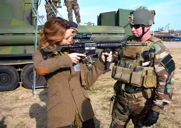 NORFOLK, Va. (Dec. 6, 2008) Chief Master-at-Arms Michael Minotto, assigned to Riverine Squadron 2, explains the functions of the M4 Battle Rifle to actress Hila
