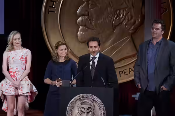 Demian Bechir and Meredith Stiehm accept the Peabody Award for The Bridge. (2014)