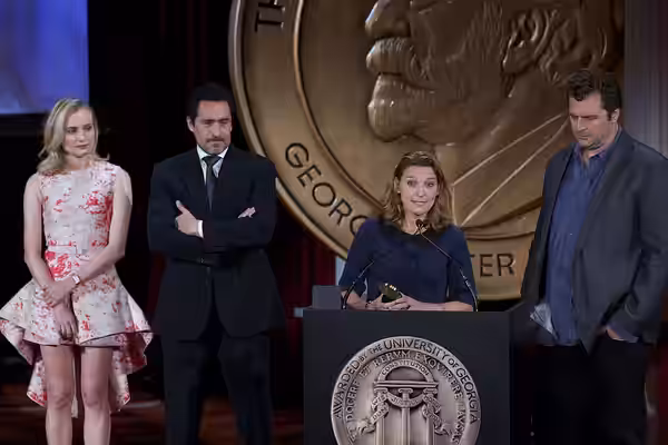 Demian Bechir and Meredith Stiehm accept the Peabody Award for The Bridge. (2014)