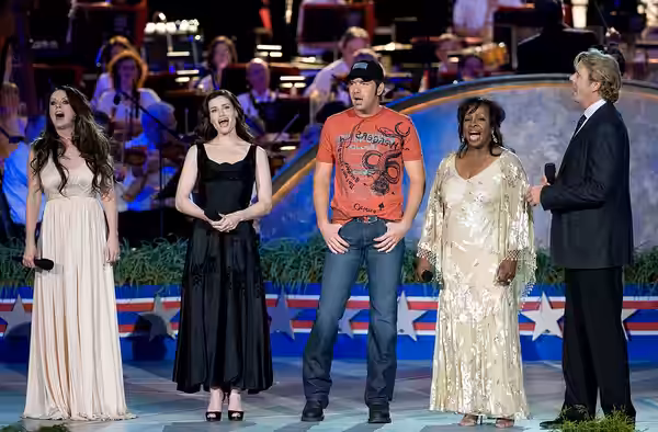 From left: Sarah Brightman, Idina Menzel, Rodney Atkins, Gladys Knight and John Schneider sing God Bless America at the conclusion of the 2008 National Memorial
