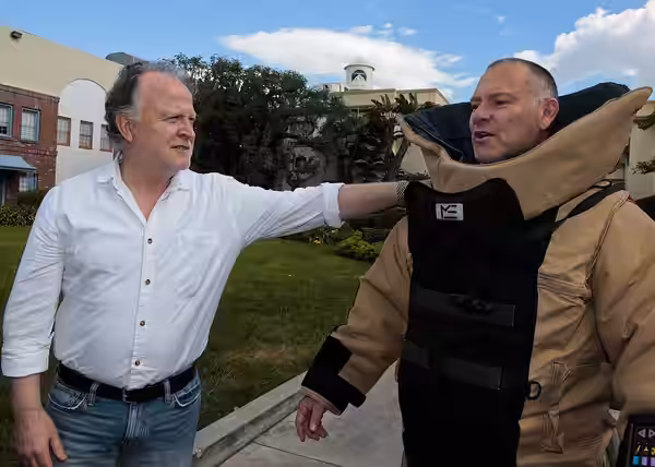 151104-N-HP195-042 LOS ANGELES -- Shane Brennan, left, attempts to gauge the thickness of the Kevlar blast suit as worn by R. Scott Gemmill, both of whom work o (2015)