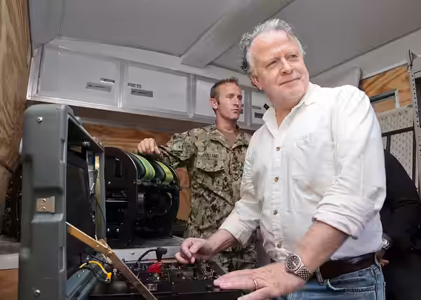 151104-N-HP195-104 LOS ANGELES -- Shane Brennan, right, executive producer on "NCIS: Los Angeles," manipulates a radio-controlled robot used by Explosive Ordnan (2015)