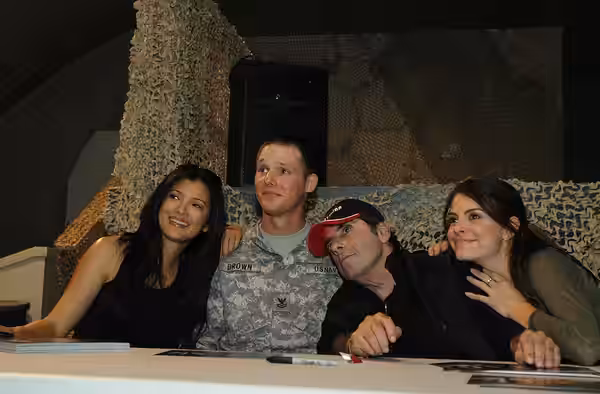 Navy Master-of-Arms 2 Daniel Brown, Farah Provincial Reconstruction Team, poses with Kelly Hu, David Proval and Maria Menounos during a morale recreation and we (2008)