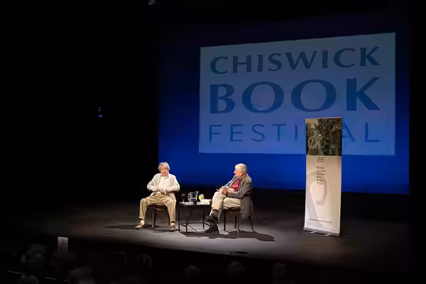Rooling Stones founding bass player Bill Wyman talking to author and film maker Tony Palmer at the 16th Chiswick Book Festival which took place during 11-18 Sep (2024)