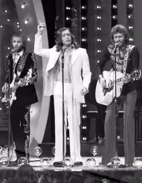 Photo of the Bee Gees performing on the television program The Midnight Special.