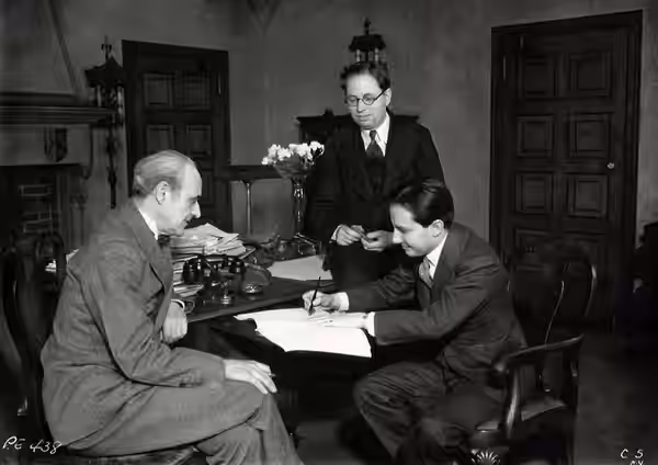 Left to right: Joseph P. Bickerton Jr. (theatre producer), Elmer Rice (playwright), and Carl Laemmle Jr. (Universal producer) sign a contract for the film versi (1933)