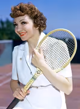 Claudette Colbert plays tennis