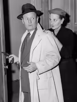 Roscoe Karns as Rocky King, is surprised by a hand on his shoulder from wife Mary Karns. (1954)