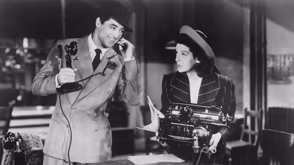Cary Grant and Rosalind Russell in the 1940 film His Girl Friday. Rosalind Russell is wearing a costume designed by costume designer Robert Kalloch.