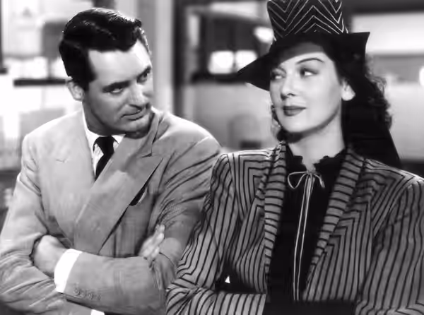 Promotional photo from the 1940 film His Girl Friday. Rosalind Russell is wearing a costume designed by costume designer Robert Kalloch. Due to a failure to ren