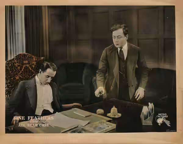 In this 1921 lobby card of Fine Feathers, In the final scene of the movie, Bob Reynolds played by Eugene Pallette, just shot John Brand played by Warburton Gamb