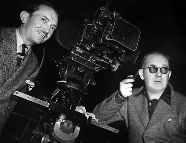 Bert Glennon (cinematographer, left) &amp; John Ford (director) on the set of Stagecoach - publicity still (1939)