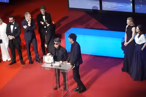Director Jafar Panahi accepting Palme d'Or for Un Simple Accident at Cannes 2025