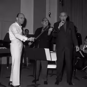 From left: Johnny Green, Jack Benny and Gregor Piatigorsky on cuckoo whistle, at Young Musicians' Foundation ball in Beverly Hills, California (1964)
