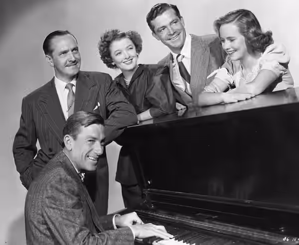 The Best Years of Our Lives, 1946 (publicity still) Standing, L-R: Frederick March, Myrna Loy, Dana Andrews, Teresa Wright; seated at piano: Hoagy Carmichael.