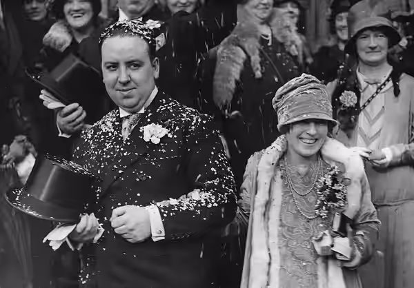 Film director Alfred Hitchcock and Alma Reville are showered with confetti after their wedding. (1926)