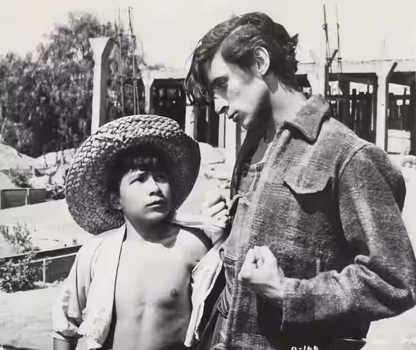 U.S. still for film Los olvidados (1950). Here appears Mario Ramírez (with hat) who portrayed "Ojitos" and Roberto Cobo who portrayed "El Jaibo".