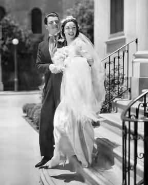 Publicity photograph of Paramount Pictures contract players Wolfe Hopper and Gail Patrick, with Patrick in a gown by Paramount designer Travis Banton (1936)