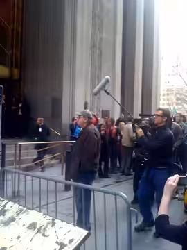 Michael Moore filming his new untitled documentary outside of the NYSE exit on Wall Street and Broadway. Photo by Shawn Chittle (Flint native)