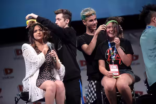 (From left to right) Bethany Mota, Troye Sivan, Kian Lawley and a supporter at the 2014 VidCon held at the Anaheim Convention Center in Anaheim, California.Plea