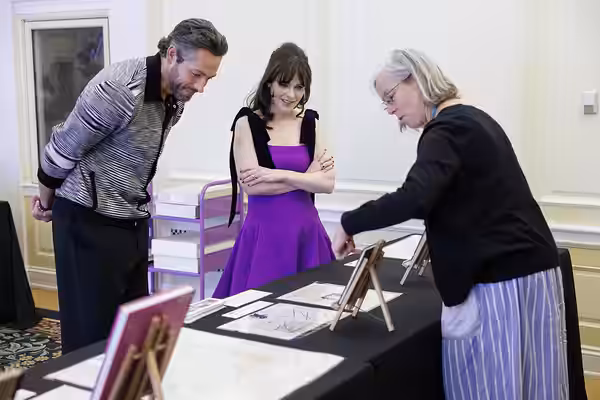 "Harold and the Purple Crayon" stars Zachary Levi and Zooey Deschanel look over a special collections display at the Library of Congress with Sara Duke, July 30 (2024)