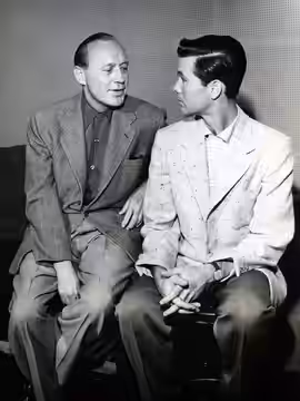 Photo of Jack Benny and young Johnny Carson as the guest on his television program The Jack Benny Show. Benny invited the young comedian to appear on his progra (1955)