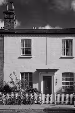 One of a terrace of mid-C19th cottages with Grade II listing. Painted brick with slate roof and dog-tooth eaves cornice. <a href="http://www.camdennewjournal (2014)