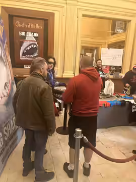 Tommy Wiseau surrounded by fans at the 2024 screening of The Room