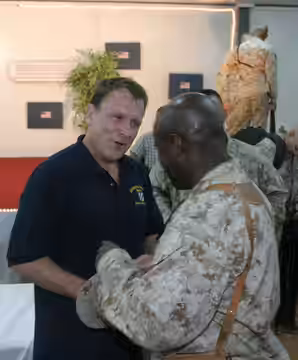 Comedian Colin Quinn shares a moment during an autograph session after the United Service Organization show on Aug. 17. Quinn and other entertainers gave Marine