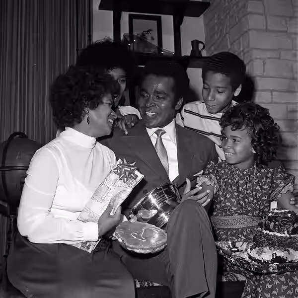 HAPPY DAD--Greg Morris takes time out on the Mission:Impossible set to accept the National Father's Day Committee's award as Television Father of the Year. Morr (1971)