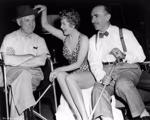 director Allan Dwan, Arlene Dahl, and cinematographer John Alton on the set on Slightly Scarlet (1956) - publicity still