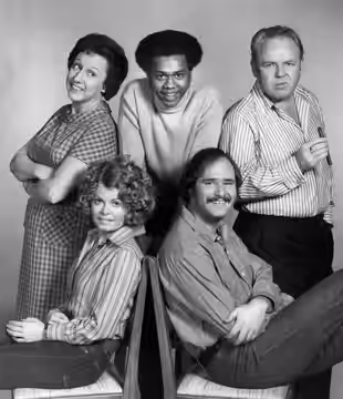 Photo of the cast of the television program All In the Family. Standing, from left: Jean Stapleton (Edith Bunker), Mike Evans (Lionel Jefferson), Carroll O'Conn