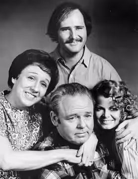 Cast photo from the television program All In the Family. Back: Rob Reiner (Mike Stivic). Front, from left: Jean Stapleton (Edith Bunker), Carroll O'Connor (Arc