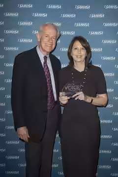 Moira Kirland with presenter Mike Farrell after accepting a 2016 Voice Award on behalf of the show Madam Secretary.