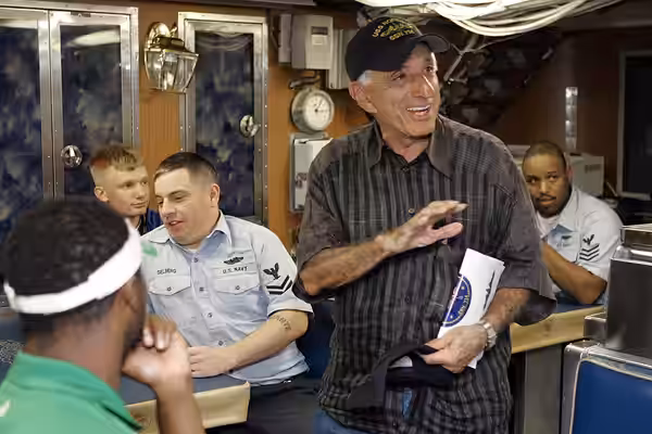Jamie Farr, who played Klinger in the television show "Mash," meets members of the crew of attack submarine USS Norfolk (SSN 714). (2007)