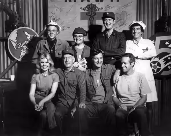 Cast photo from MAS*H for 1977. Front row from left-Loretta Swit, Harry Morgan, Alan Alda, Mike Farrell. Back row from left-William Christopher, Gary Burghoff