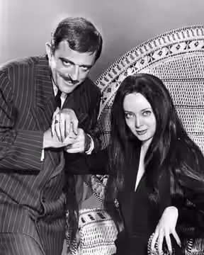Photo of John Astin and Carolyn Jones as Gomez and Morticia Addams from The Addams Family. (1964)