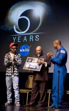 Music legend Quincy Jones, center, was presented with a montage by astronaut Leland Melvin, right, as hip-hop artist/producer Pharrell Williams looks on at a ce (2008)