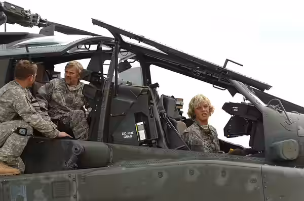 Veteran actor Ricky Schroder and son Luke (right), take the pilot and co-pilot seat in the Apache AH-64 helicopter during a visit to Fort Hood, Texas, May 1. Be