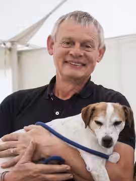 Martin Clunes and his Terrier Jim on his annual Buckham Fair , a vintage family fair , Beaminster, Buckham Down, West Dorset, UK (2018)
