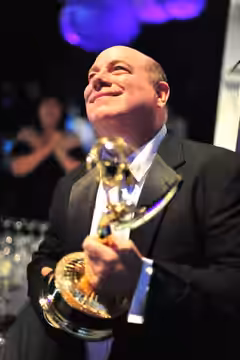 Mike Rowe accepts the 2011 Emmy along with the writing staff of Futurama for Best Animated Primetime Series