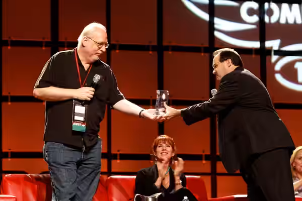J. Michael Straczynski speaking at the 2013 Phoenix Comicon at the Phoenix Convention Center in Phoenix, Arizona, and being presented an award by John Edwards. 