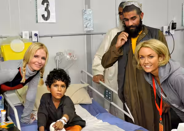 KANDAHAR AIRFIELD, Afghanistan - Celebrities Vanessa Branch and Kelly Carlson spread some cheer Oct. 13 at the Role III coalition hospital here to an Afghan chi (2009)