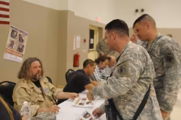 Cast members of the FX show "Sons of Anarchy" sign autographs for service members during a meet and greet, March 16, at Joint Base Balad, Iraq. (2010)