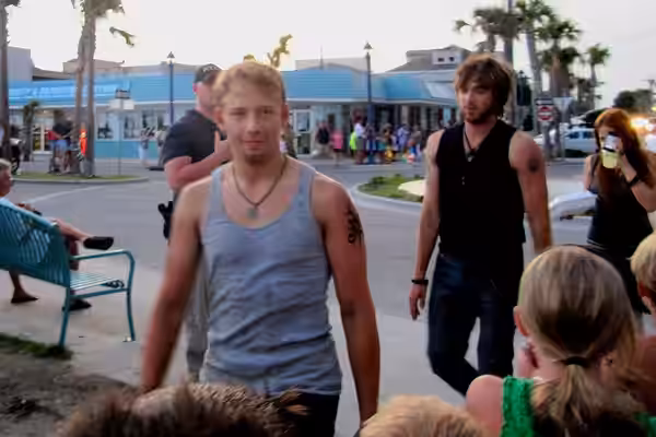From left to right, cast members Adam Barnett, Nick Lashaway, and Carly Chaikin make their way to the filming of the bonfire scene under the Tybee Island pavili (2009)