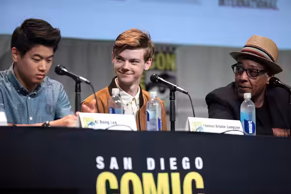 Ki Hong Lee, Thomas Brodie-Sangster and Giancarlo Esposito speaking at the 2015 San Diego Comic Con International, for "Maze Runner: The Scorch Trials", at the 