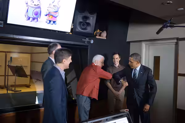 President Barack Obama greets Steve Martin during a tour of the Glendale campus of movie studio DreamWorks Animation SKG in Glendale, Calif., Nov. 26, 2013.