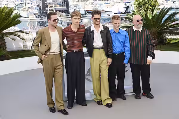The cast of "Coward" pose during a photocall at the 2026 Cannes Film Festival