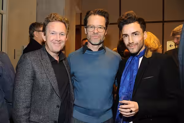Crew members of the movie "Genius" at the 2016 Berlinale party of U.S. Embassy Berlin. L to R: John Logan (writer), Guy Pearce, and Tommy Tonge