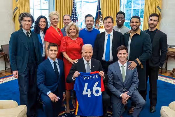 President Joe Biden, holding an AFC Richmond jersey, and First Lady Jill Biden greet the cast of “Ted Lasso” on Monday, March 20, 2023, in the Oval Office of th